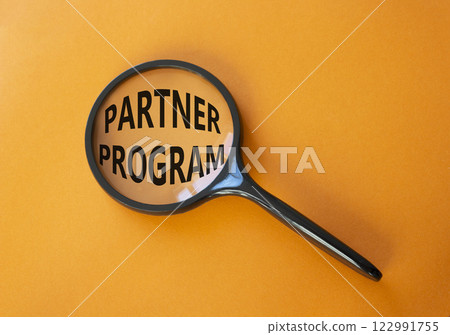 Partner Program symbol. Concept words Partner Program on magnifying glass. Beautiful orange background. Business and Partner Program concept. Copy space. Partner Program symbol. Concept words Partner Program on magnifying glass. Beautiful orange background. Business and Partner Program concept. Copy space. 122991755