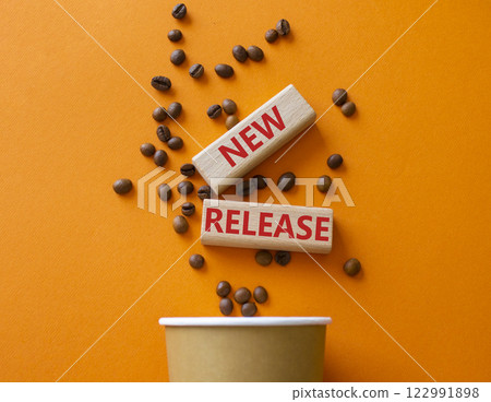 New Release symbol. Concept word New Release on wooden blocks. Beautiful orange background with coffee cup. Business and New Release concept. Copy space New Release symbol. Concept word New Release on wooden blocks. Beautiful orange background with coffee cup. Business and New Release concept. Copy space 122991898