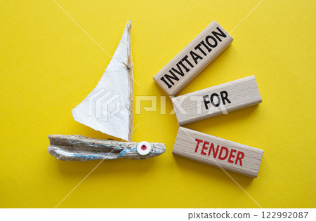 Invitation for Tender symbol. Concept words Invitation for Tender on wooden blocks. Beautiful yellow background with boat. Business concept. Copy space. Invitation for Tender symbol. Concept words Invitation for Tender on wooden blocks. Beautiful yellow background with boat. Business concept. Copy space. 122992087