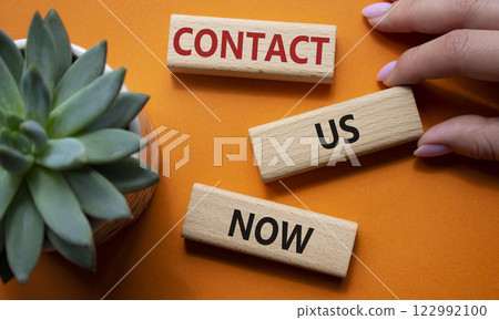 Contact us now symbol. Wooden blocks with words Contact us now. Beautiful orange background with succulent plant. Businessman hand. Business and Contact us now concept. Copy space. 122992100
