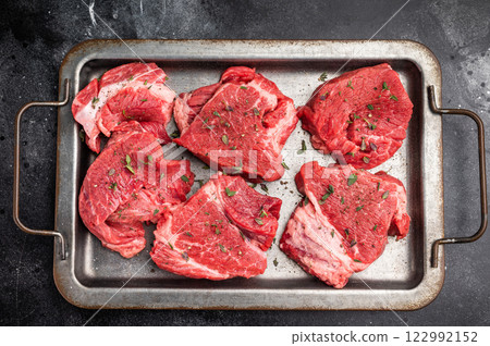 Raw beef boneless shank shin meat with herbs and spices ready for cooking. isolated on white background. top view Raw beef boneless shank shin meat with herbs and spices ready for cooking. isolated on white background. top view 122992152