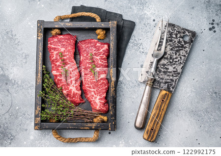 Exquisite beef shoulder tender, denver steak waiting to be transformed into a gourmet dish. Ideal for grilling or roasting for an unforgettable dinner. grey background. top view 122992175