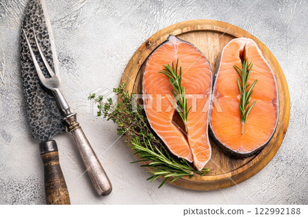 Premium salmon loin steak, expertly cut and displayed, perfect for culinary creations. Elevate your dishes with this delicious seafood option. grey background. top view 122992188