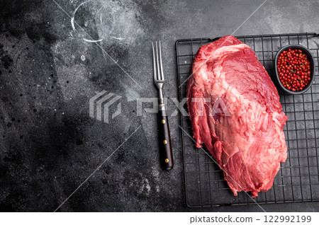 Close-up of raw boneless beef shank cuts, highlighting their tender texture and vibrant hue, ideal for culinary enthusiasts seeking quality ingredients. black background. top view 122992199