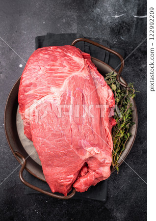 Raw Top Round beef meat cut, topside with hrebs for roast. black background. Top view Raw Top Round beef meat cut, topside with hrebs for roast. black background. Top view 122992209
