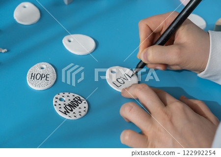 Master class writing word LOVE on EASTER egg Children air dry clay activity handicraft idea. DIY process step by step instruction. Preparing for Easter holiday decorating. Modern organic design 122992254