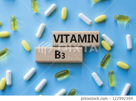 Vitamin B3 symbol. Concept word Vitamin B3 on wooden blocks. Beautiful blue background with pills. Medicine and Vitamin B3 concept. Copy space Vitamin B3 symbol. Concept word Vitamin B3 on wooden blocks. Beautiful blue background with pills. Medicine and Vitamin B3 concept. Copy space 122992304