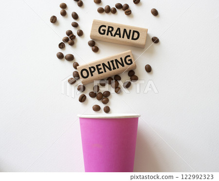 Grand Opening symbol. Concept word Grand Opening on wooden blocks. Beautiful white background with coffee cup. Business and Grand Opening concept. Copy space 122992323