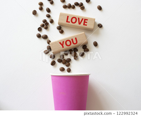 Love you symbol. Concept word Love you on wooden blocks. Beautiful white background with coffee cup. Business and Love you concept. Copy space 122992324