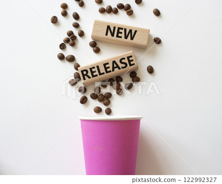 New Release symbol. Concept word New Release on wooden blocks. Beautiful white background with coffee cup. Business and New Release concept. Copy space 122992327