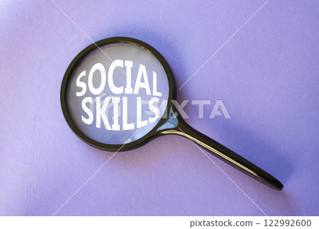 Social skills symbol. Concept words Social skills on magnifying glass. Beautiful purple background. Business and Social skills concept. Copy space. 122992600