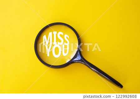 Miss you symbol. Magnifying Glass with Concept word Miss you. Beautiful yellow background. Miss you concept. Copy space Miss you symbol. Magnifying Glass with Concept word Miss you. Beautiful yellow background. Miss you concept. Copy space 122992608