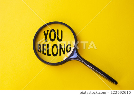 You belong symbol. Concept words You belong on magnifying glass. Beautiful yellow background. Business and You belong concept. Copy space. You belong symbol. Concept words You belong on magnifying glass. Beautiful yellow background. Business and You belong concept. Copy space. 122992610