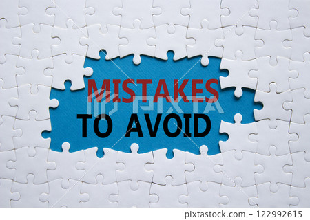 Mistakes symbol. Concept words Mistakes to Avoid on white puzzle. Beautiful blue background Business and Mistakes to Avoid concept. Copy space. 122992615