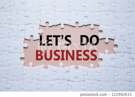 Lets do business symbol. Concept words Lets do business on white puzzle. Beautiful pink background. Business and Lets do business concept. Copy space. 122992631