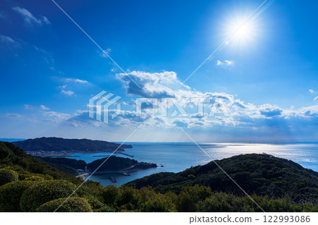 Wakayama Kada Port bathed in the soft winter sunlight. Clouds near the horizon and the shining sun. 122993086