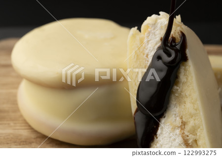 White chocolate cake with chocolate sauce White chocolate cake with chocolate sauce 122993275