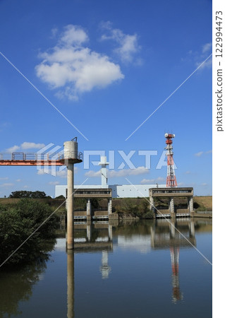 The area around the Misato Floodway flowing into the Edogawa River with blue skies and clouds The area around the Misato Floodway flowing into the Edogawa River with blue skies and clouds 122994473