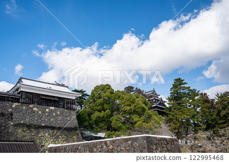 Snow still remains on the turrets and walls of Matsue Castle, with the castle tower standing in the distance Snow still remains on the turrets and walls of Matsue Castle, with the castle tower standing in the distance 122995468