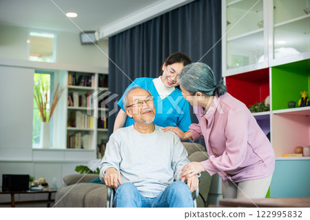 Asian old man on wheelchair with couple and nurse relaxing walking at home, healthcare medical service at nursing home, Happy nurse and wife support retirement senior elderly man Asian old man on wheelchair with couple and nurse relaxing walking at home, healthcare medical service at nursing home, Happy nurse and wife support retirement senior elderly man 122995832