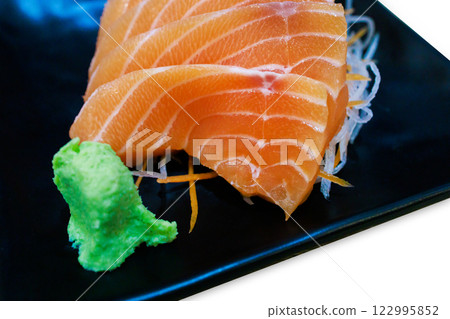 Top view of Fresh slice Salmon on the black plate, focus selective 122995852