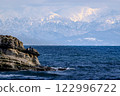 Noto Peninsula Nanao City Coastline Hotokejima Island and the Tateyama mountain range with sunlight shining through the clouds 122996722