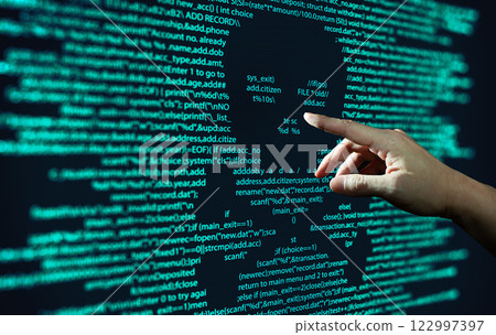 Human hand points at abstract Modern tech of Programming code screen with skull. Computer Virus, Malware, and Hacker Attack Concept. 122997397