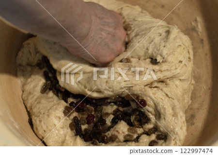 kneading yeast dough with raisins, female hands, baking kneading yeast dough with raisins, female hands, baking 122997474