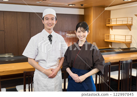 Smiling employee working at a Japanese restaurant Smiling employee working at a Japanese restaurant 122997845