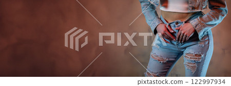 A Fashionable Woman in a Stylish Distressed Denim Outfit that Captures Attention A Fashionable Woman in a Stylish Distressed Denim Outfit that Captures Attention 122997934