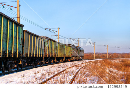 Heavy iron ore freight train for Poland in winter. Kovel, Volyn Oblast of Ukraine 122998249