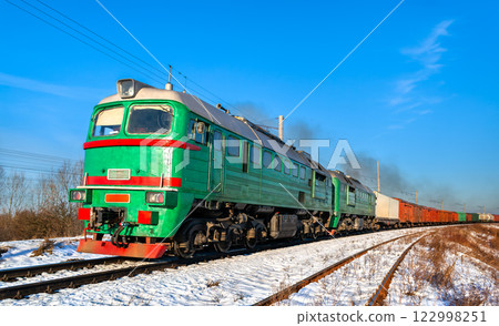 Diesel locomotive with a heavy freight train in winter in Kovel, Volyn Oblast of Ukraine 122998251