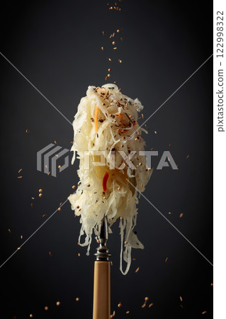 Traditional German sauerkraut with spices on a fork. 122998322