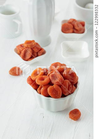 Organic dried apricots on a white table. Organic dried apricots on a white table. 122998332