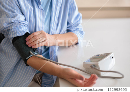 Women's hands measure their own blood pressure with a tonometer. Concept hypotension 122998693