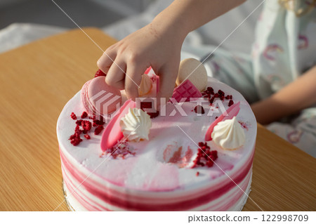 Indulge in Our Delicious Cake Delightfully Topped with Exquisite Macarons and Creamy Frosting Indulge in Our Delicious Cake Delightfully Topped with Exquisite Macarons and Creamy Frosting 122998709
