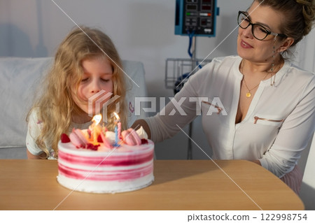 Celebrating a birthday in a hospital room adorned with joyful cake and bright decorations 122998754