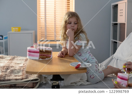 A young child happily enjoys a colorful snack in a bright, cheerful hospital room A young child happily enjoys a colorful snack in a bright, cheerful hospital room 122998769