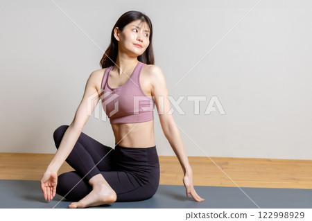 Beautiful woman in sportswear stretching 122998929
