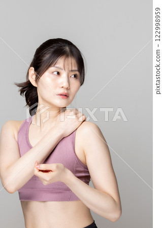 Beautiful woman in sportswear stretching 122998959