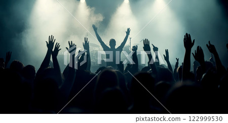 Energetic concert crowd with hands raised in silhouette. Energetic concert crowd with hands raised in silhouette. 122999530
