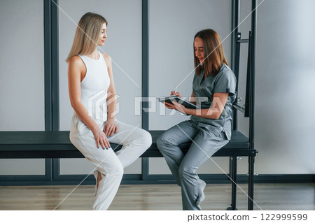 Talking with each other. Woman is in health center getting help by doctor 122999599