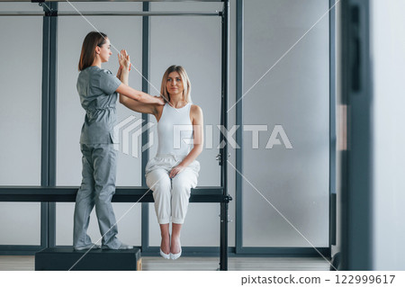 Moving the hand. Woman is in health center getting help by doctor 122999617