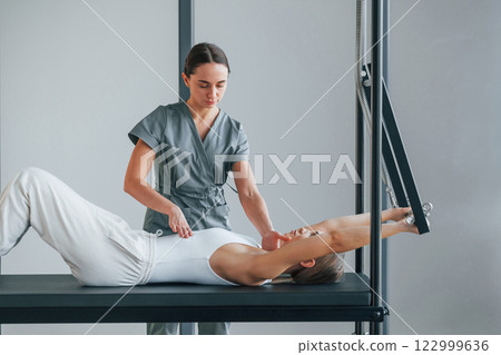 Laying down. Woman is in health center getting help by doctor 122999636