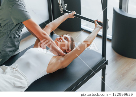 Laying down. Woman is in health center getting help by doctor Laying down. Woman is in health center getting help by doctor 122999639