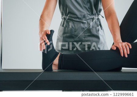 Active exercises. Woman is in health center getting help by doctor Active exercises. Woman is in health center getting help by doctor 122999661