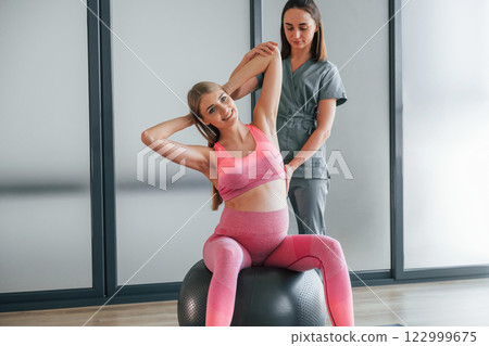 Pregnant woman is in health center getting help by doctor 122999675
