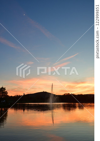 Metz, France. Artificial lake and the moon during magic hour on May 11, 2024. 122999851