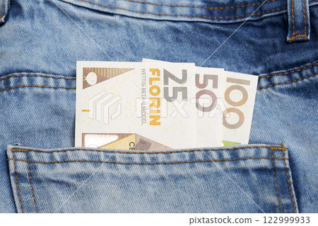 Aruban florin in the pocket of blue jeans Aruban florin in the pocket of blue jeans 122999933