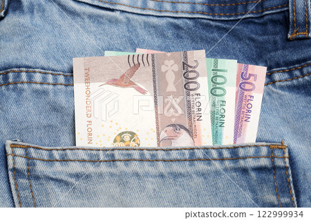 Aruban florin in the pocket of blue jeans 122999934